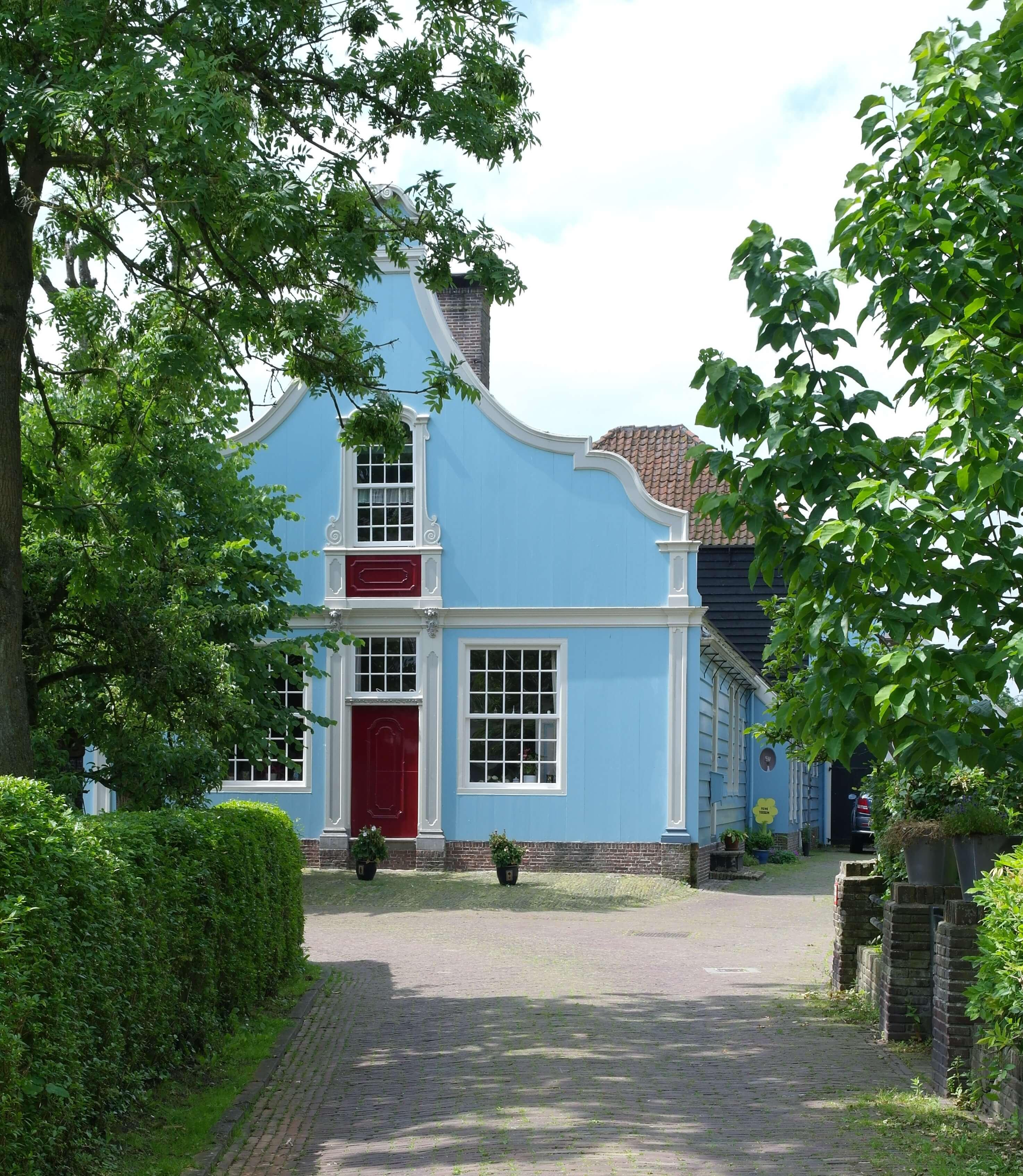 Wooden blue Duch heritage building in de village of broek in Waterland, just outside Amsterdam